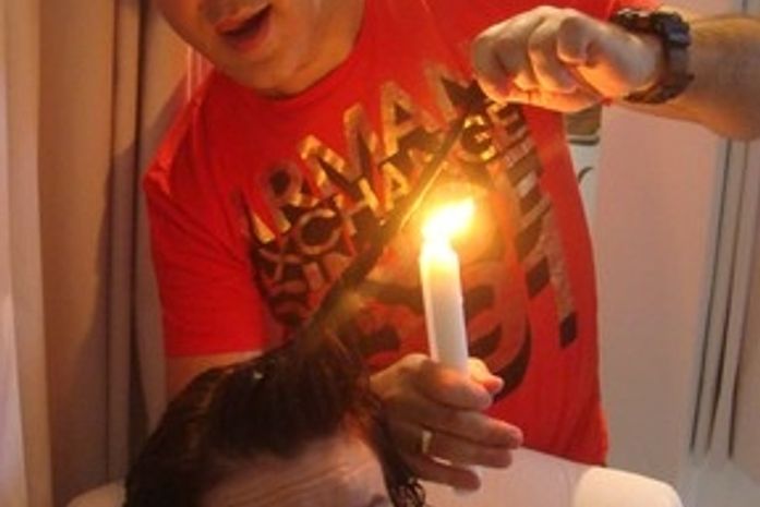 Tratamento curioso: Cláudia Rodrigues corta cabelo com vela e faca