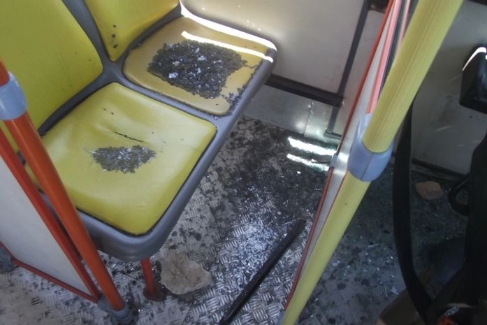 Interior do ônibus com estilhaços de vidro