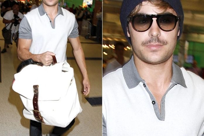 Zac Efron exibe novo visual em aeroporto