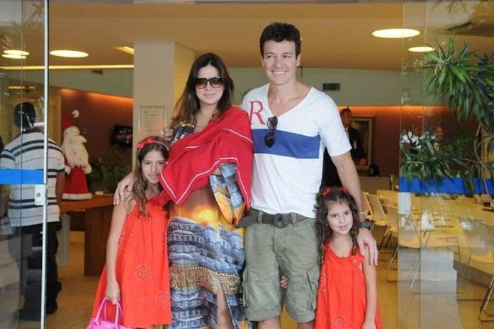 Vera Viel deixa a maternidade com filha Helena no colo