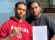 Rehan Staton ao lado de seu irmão, Reggie, segurando sua carta de aceitação para a Escola de Direito de Harvard
