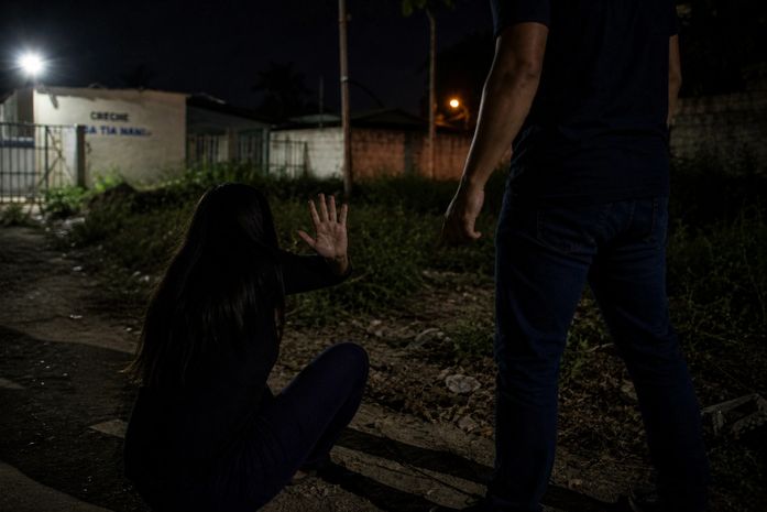 Homem agredindo mulher em terreno baldio