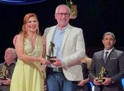 Maurício recebendo o troféu da coordenadora do evento Francis Núbia